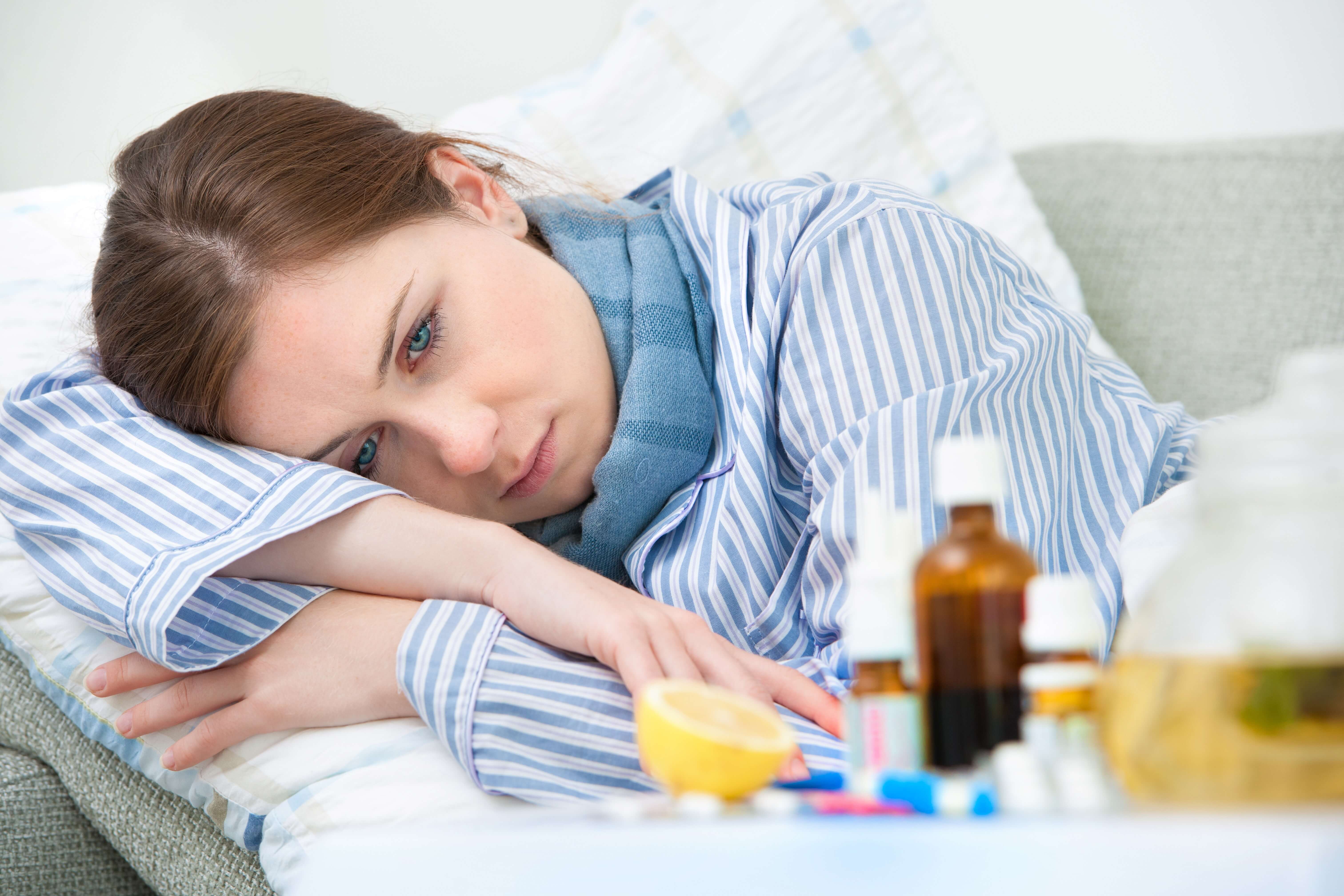 Sick woman lying in bed